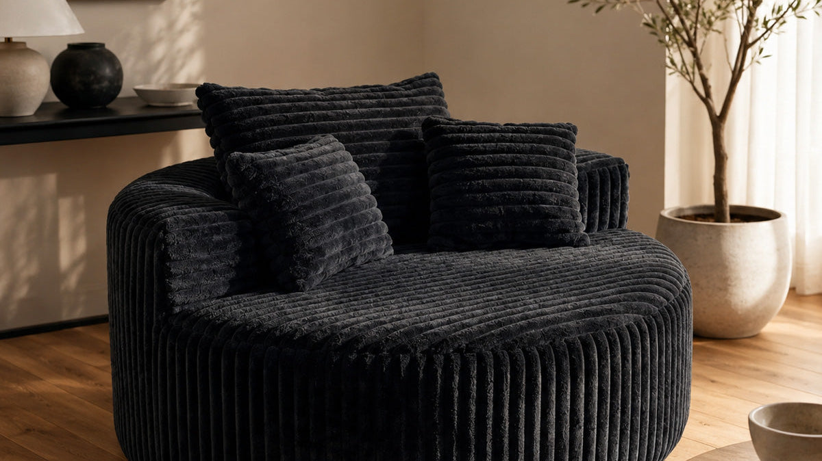 Oversized round corduroy lounge chair styled as a bedroom reading nook