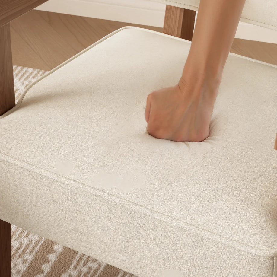 Hand pressing the padded armchair seat