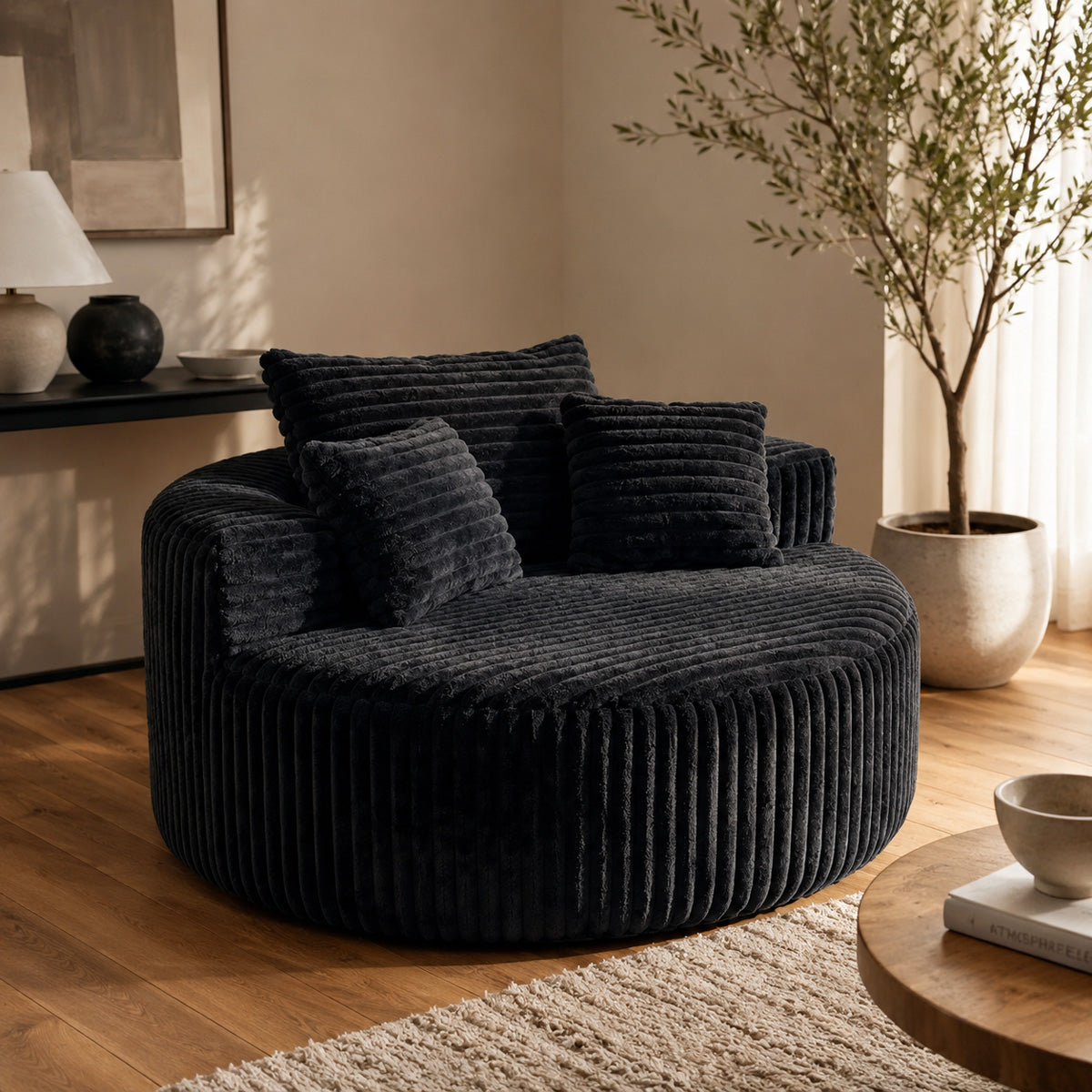 Oversized round corduroy lounge chair styled as a bedroom reading nook
