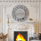 Round sunburst wall mirror 31.5 inch silver glass above a fireplace