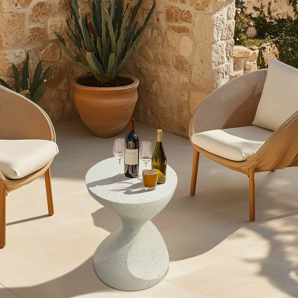 White hourglass concrete side table on a patio