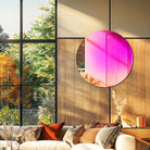 Rainbow gradient round wall mirror above a sofa