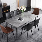 Grey sintered stone dining table with black chairs