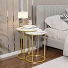 Nesting side tables beside a bed