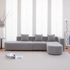Grey bouclé L-shaped sectional sofa with curved round seat, facing right
