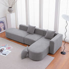 Grey bouclé L-shaped sectional sofa with curved round seat, facing right