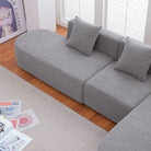 Grey bouclé L-shaped sectional sofa with curved round seat, facing right